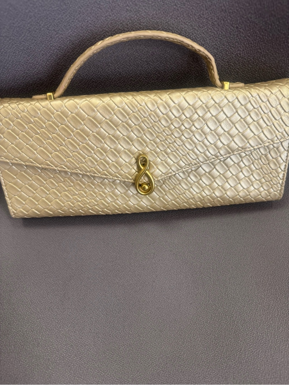 Gold Textured Top-Handle Clutch Bag